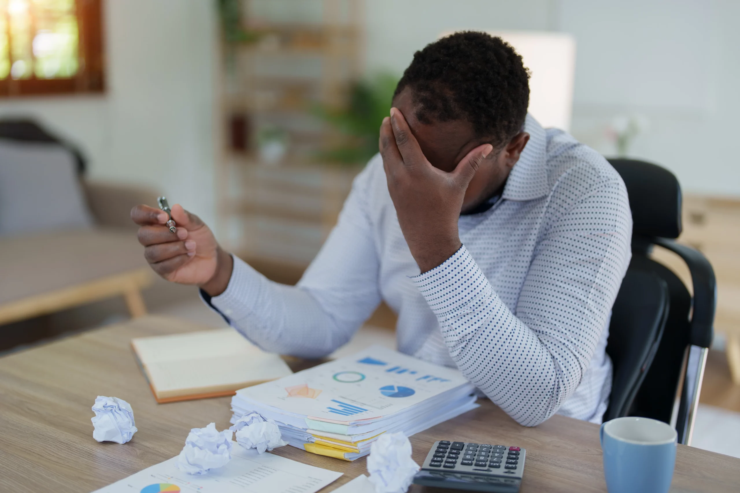 Burned-out businessman experiencing stress at work, illustrating the financial pressure of managing buy now, pay later debt before filing for bankruptcy in Tennessee.