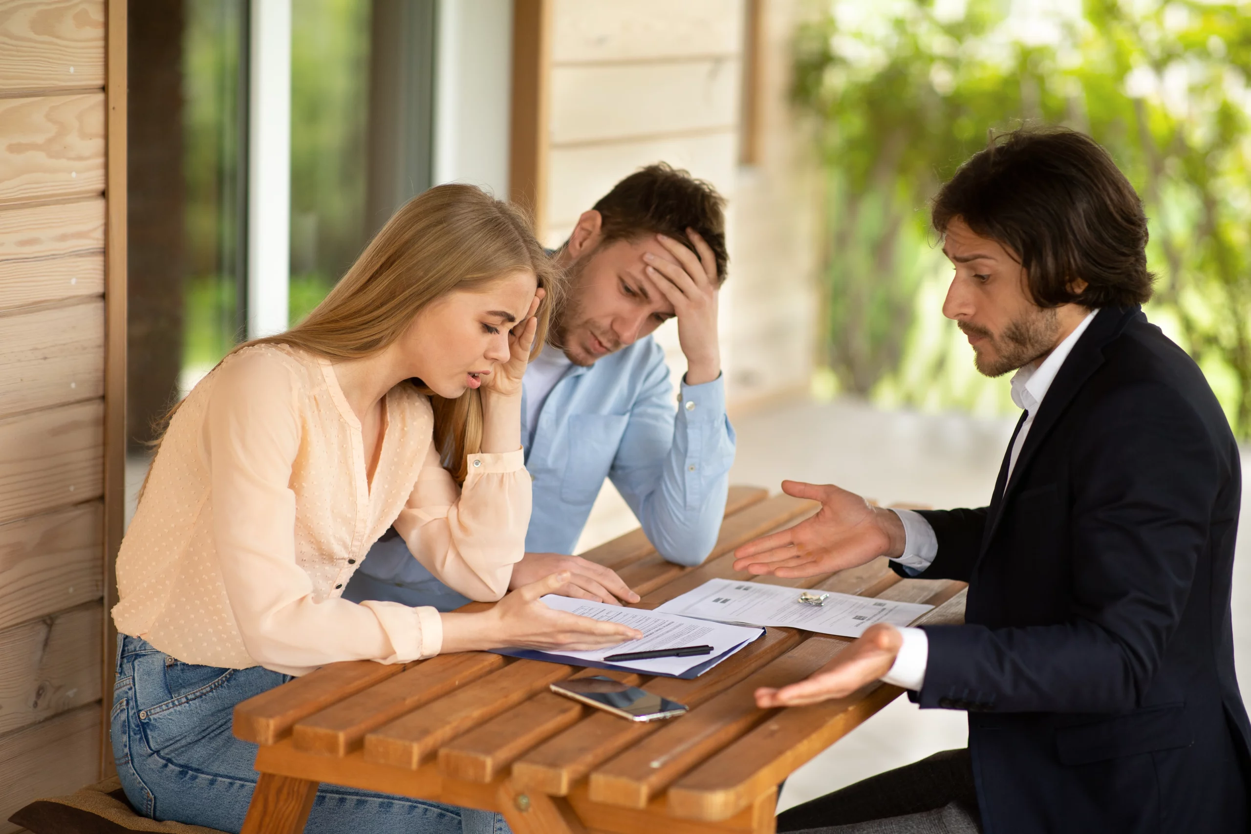 Concerned couple discussing co-signer responsibilities and bankruptcy in Tennessee with a financial advisor